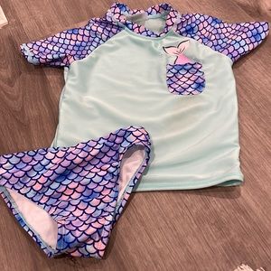 Mermaid bathing suit.  Top does have a stain and bottom is pilling slightly